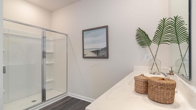 bathroom featuring an enclosed shower, vanity, and hardwood / wood-style floors