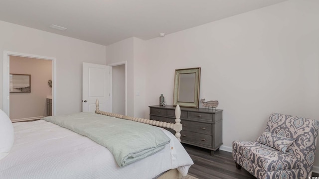 bedroom with dark hardwood / wood-style flooring