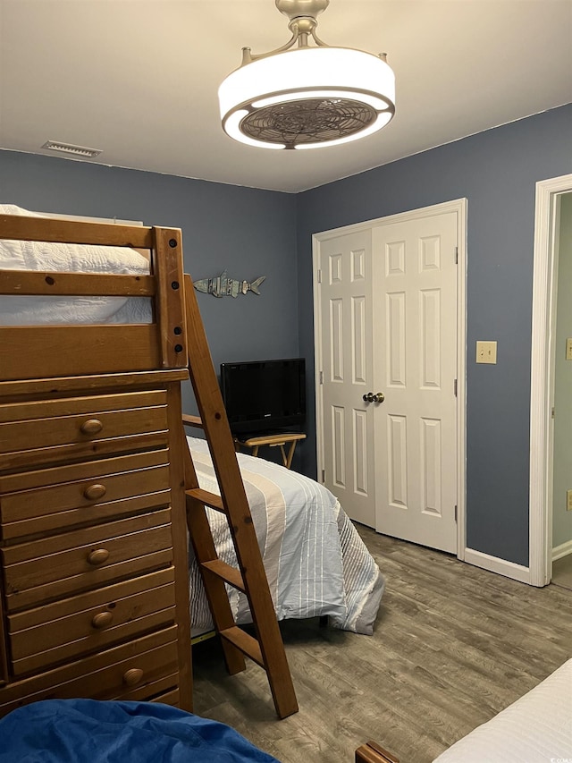 bedroom featuring hardwood / wood-style flooring and a closet