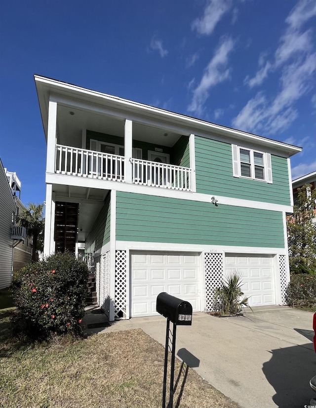 view of front of home with a garage and a balcony