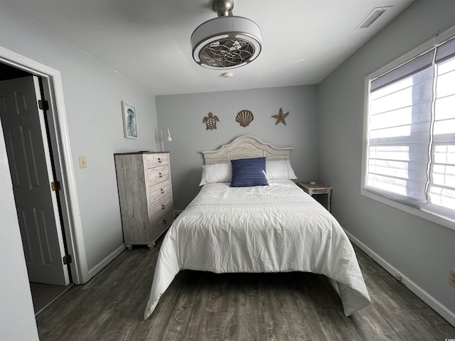 bedroom with ceiling fan and dark hardwood / wood-style flooring