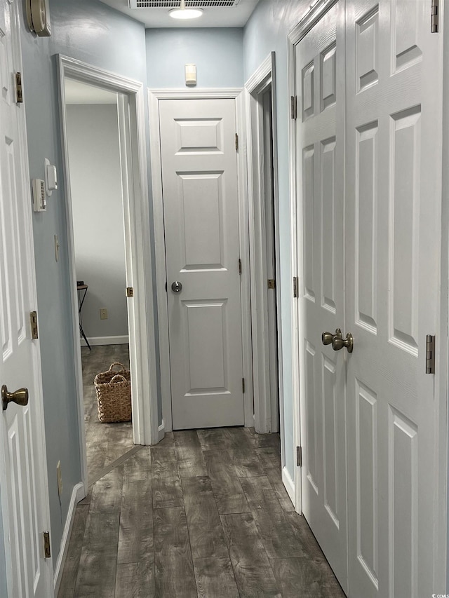 hallway featuring dark hardwood / wood-style flooring