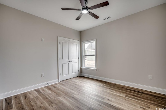 spare room with light hardwood / wood-style flooring and ceiling fan