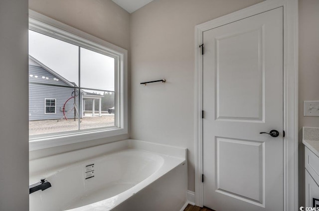 bathroom featuring vanity and a tub