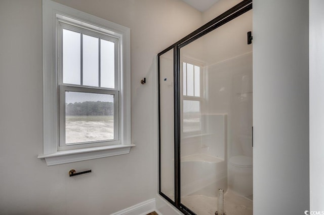 bathroom with a shower with door