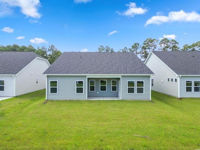 rear view of house featuring a patio and a lawn