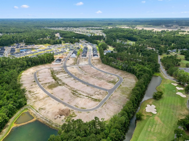 birds eye view of property featuring a view of trees and a water view