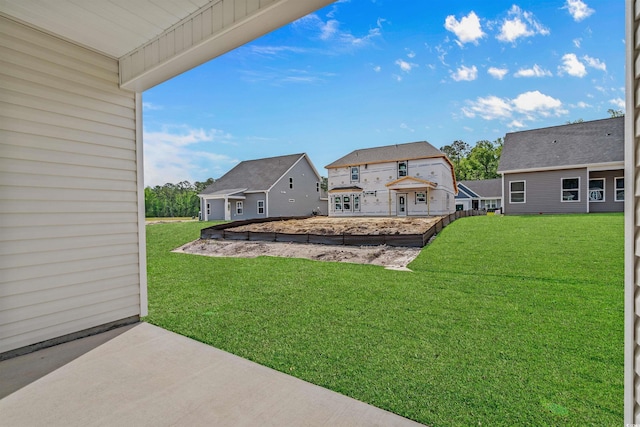 view of yard featuring a patio and a residential view