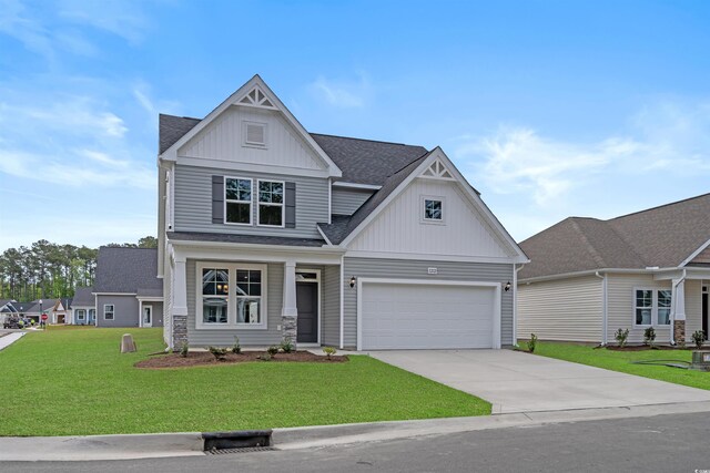 1212 NW Calabash Station Blvd, Calabash, NC 28467 - view of front of property with a front yard, a garage, a shingled roof, board and batten siding, and concrete driveway