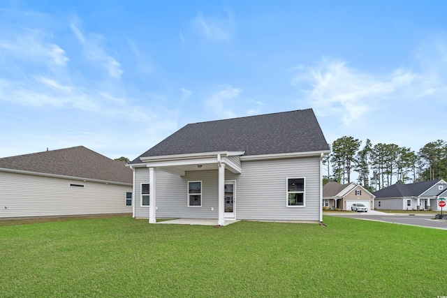 1212 NW Calabash Station Blvd, Calabash, NC 28467 - back of house featuring a lawn, roof with shingles, and a patio area