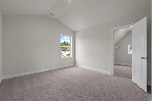 1212 NW Calabash Station Blvd, Calabash, NC 28467 - interior space with visible vents, baseboards, carpet floors, vaulted ceiling, and a walk in closet
