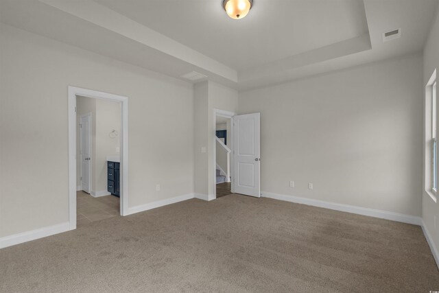 1212 NW Calabash Station Blvd, Calabash, NC 28467 - unfurnished bedroom featuring a raised ceiling, visible vents, baseboards, and carpet floors