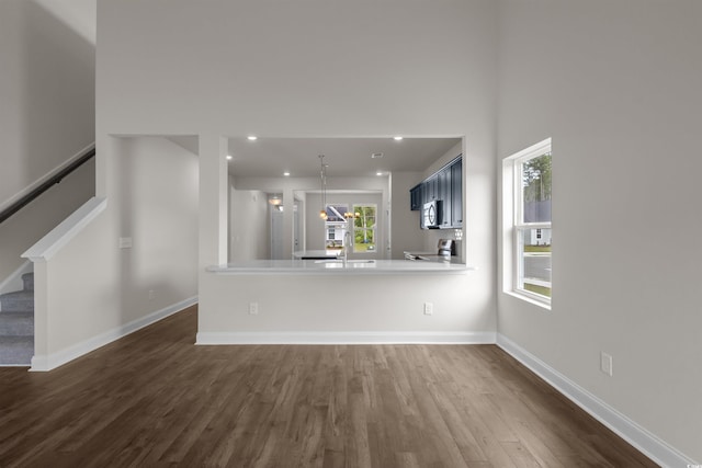 1212 NW Calabash Station Blvd, Calabash, NC 28467 - unfurnished living room featuring baseboards, recessed lighting, stairs, and dark wood-style flooring