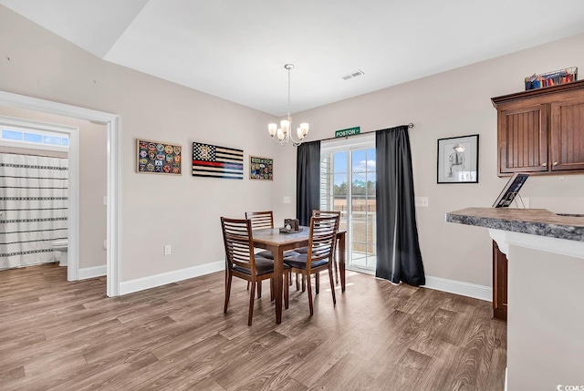 dining space featuring an inviting chandelier and hardwood / wood-style floors