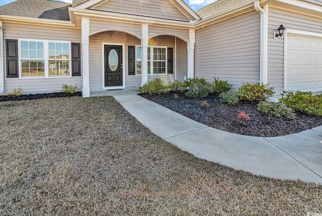 property entrance with a garage and covered porch