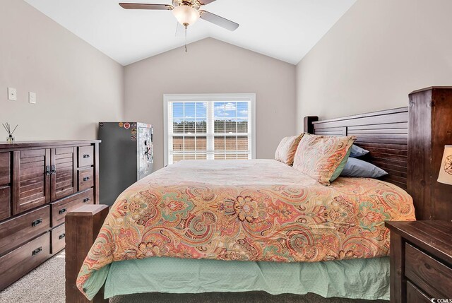 carpeted bedroom with vaulted ceiling and ceiling fan