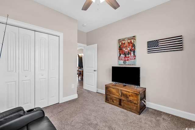 living area with light colored carpet and ceiling fan