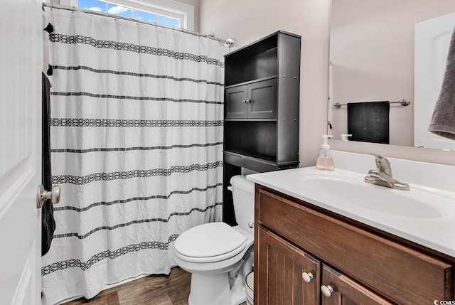 bathroom with vanity, wood-type flooring, and toilet