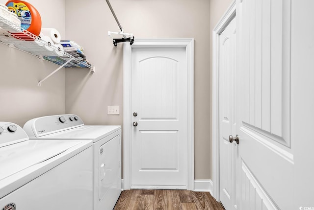 laundry room with dark hardwood / wood-style floors and washer and dryer