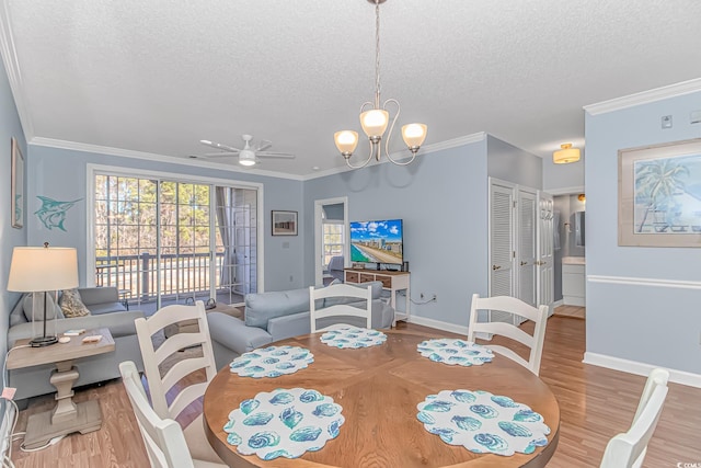 dining space with crown molding, a textured ceiling, and light wood-type flooring