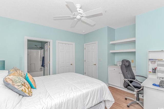 bedroom featuring a textured ceiling, light hardwood / wood-style floors, ceiling fan, and ensuite bathroom