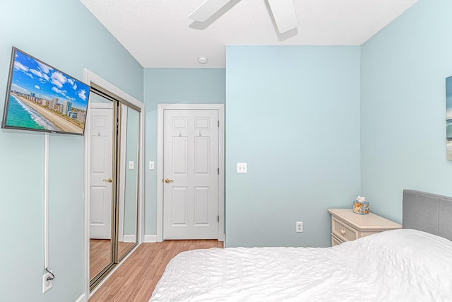 bedroom featuring a closet, ceiling fan, and light wood-type flooring