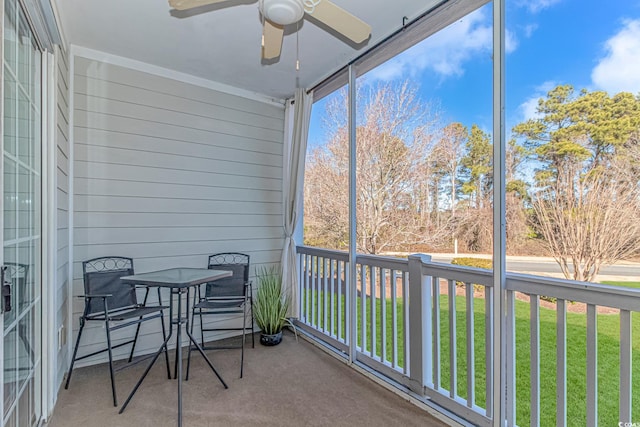 sunroom / solarium featuring ceiling fan and plenty of natural light