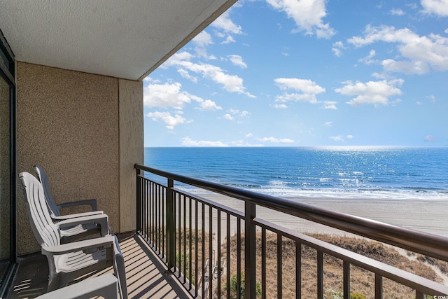 balcony featuring a water view and a view of the beach