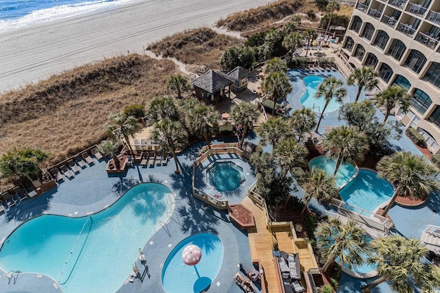 aerial view with a water view and a view of the beach