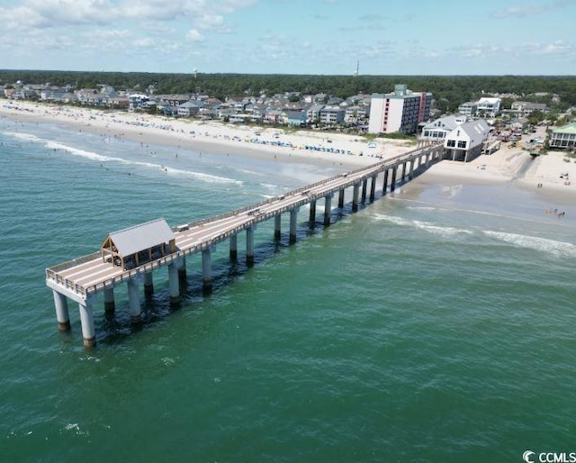 drone / aerial view featuring a water view and a view of the beach