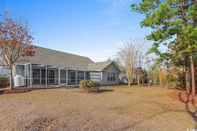 back of house with a lawn