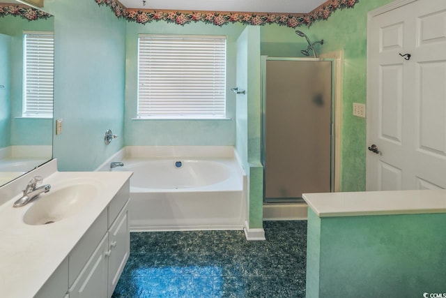 bathroom featuring vanity, separate shower and tub, and a wealth of natural light