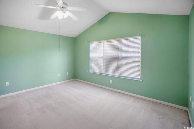 empty room with light carpet, vaulted ceiling, and ceiling fan