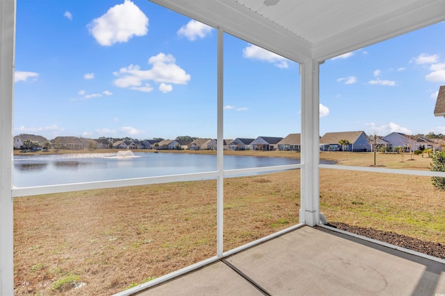 unfurnished sunroom with a water view