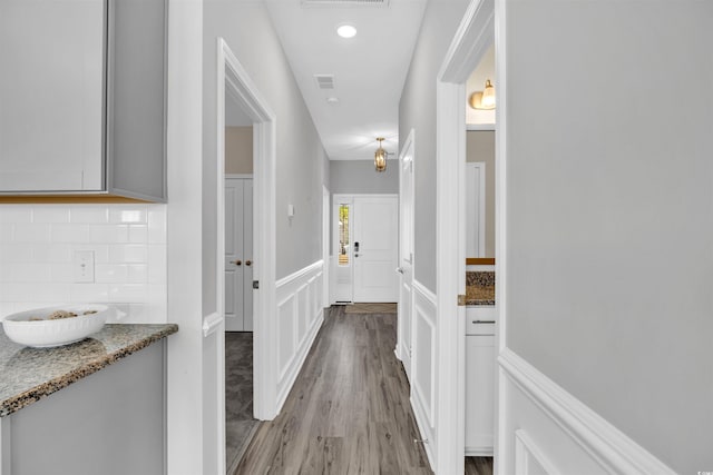 hallway with light hardwood / wood-style floors