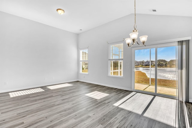 interior space featuring hardwood / wood-style flooring, lofted ceiling, and a chandelier