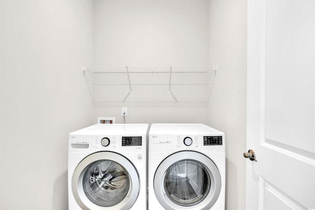 clothes washing area with separate washer and dryer