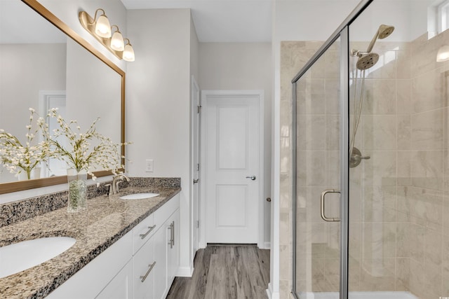 bathroom featuring vanity, hardwood / wood-style floors, and walk in shower