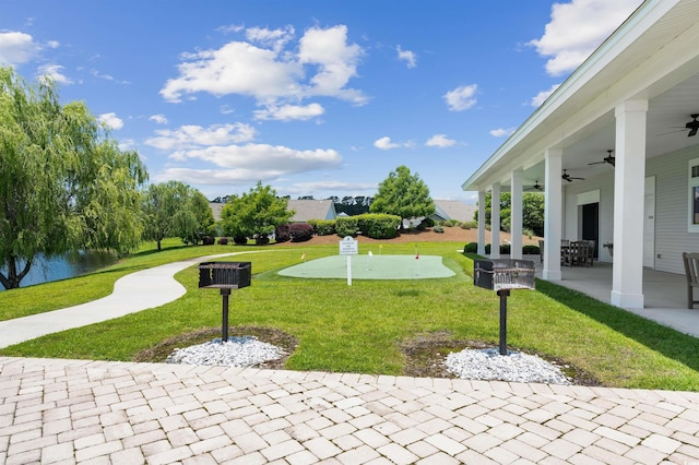 exterior space with a water view and ceiling fan