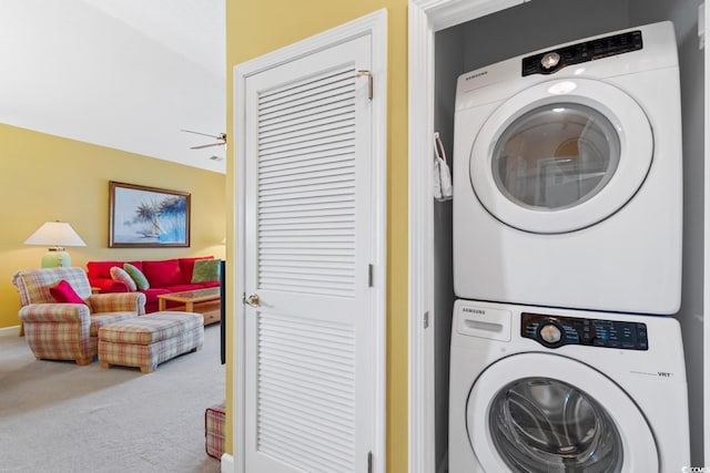 washroom with laundry area, stacked washer and clothes dryer, a ceiling fan, and carpet floors