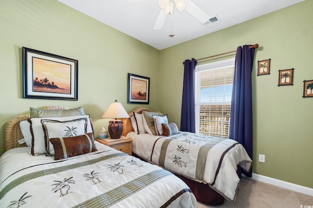 carpeted bedroom featuring visible vents, a ceiling fan, and baseboards