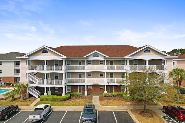 view of building exterior featuring uncovered parking