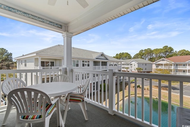 balcony featuring outdoor dining space, a ceiling fan, and a residential view