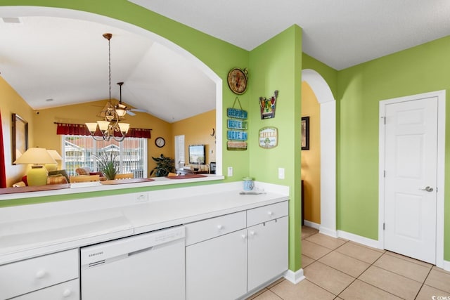 kitchen featuring white cabinetry, white dishwasher, light countertops, light tile patterned floors, and vaulted ceiling