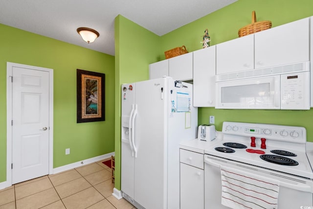 kitchen featuring white appliances, light tile patterned floors, baseboards, light countertops, and white cabinets