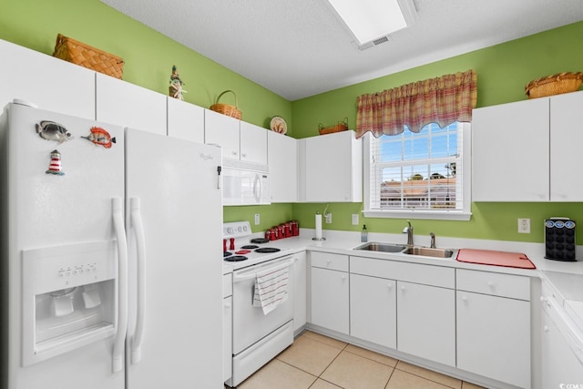 kitchen featuring a sink, white cabinetry, white appliances, light countertops, and light tile patterned floors