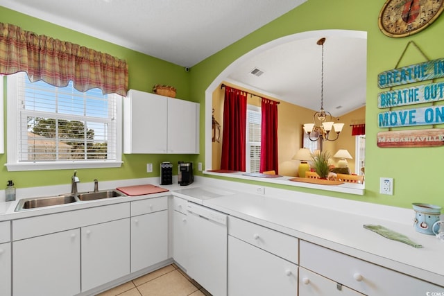 kitchen with a sink, a healthy amount of sunlight, white dishwasher, and light tile patterned floors