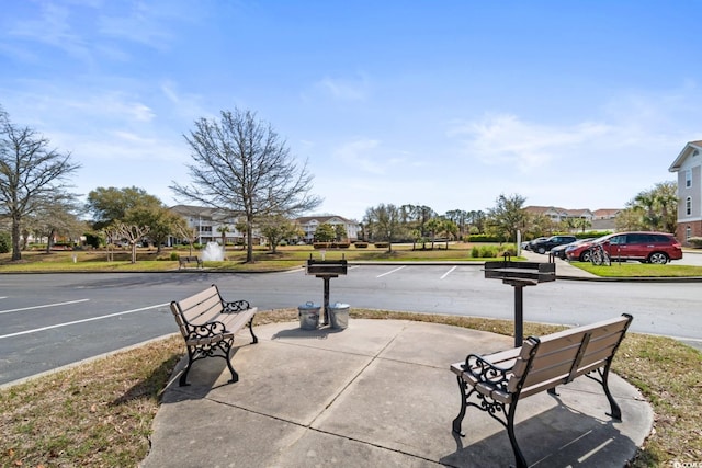 view of road with a residential view, curbs, and sidewalks