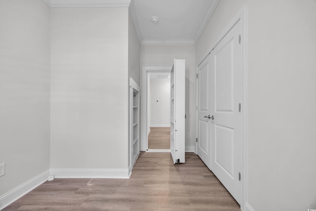 corridor featuring light hardwood / wood-style flooring and crown molding