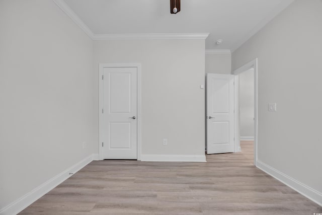 unfurnished bedroom featuring light hardwood / wood-style floors and crown molding